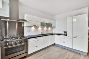Lathomz modular kitchen with glossy white cabinets, stainless steel appliances, and minimalist modern design